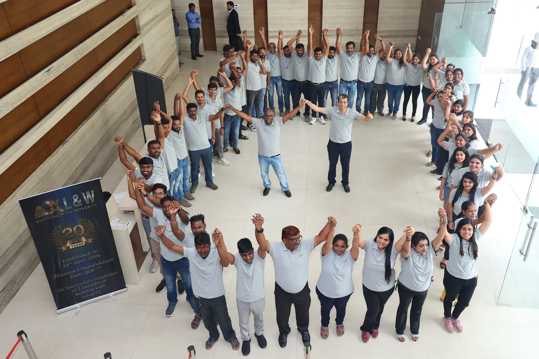 The L&W team in a circle at the 20th anniversary celebration